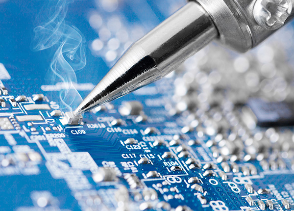 Microcircuit being fixed with soldering iron - very sharp micro photo